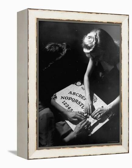 People Playing with a Ouija Board-Wallace Kirkland-Framed Premier Image Canvas