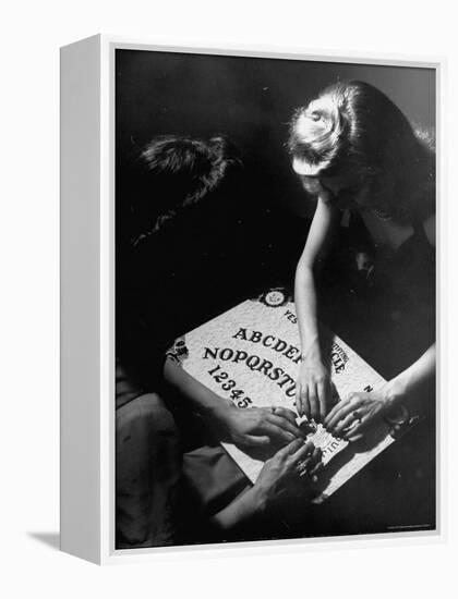 People Playing with a Ouija Board-Wallace Kirkland-Framed Premier Image Canvas