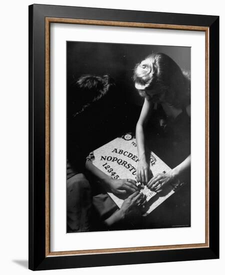 People Playing with a Ouija Board-Wallace Kirkland-Framed Photographic Print