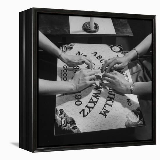 People Playing with a Ouija Board-null-Framed Premier Image Canvas