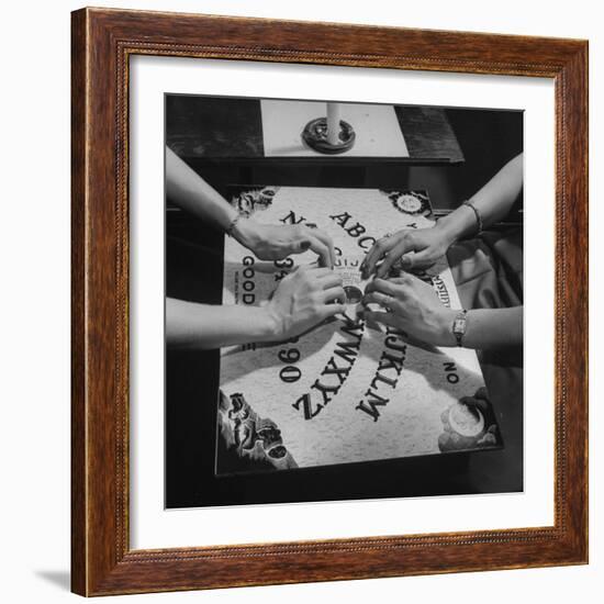 People Playing with a Ouija Board-null-Framed Photographic Print