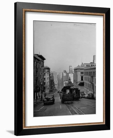 People Riding on Dual Cable Cars, with Bay Bridge Sitting in Background-Charles E^ Steinheimer-Framed Photographic Print