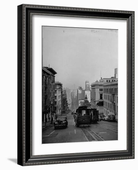 People Riding on Dual Cable Cars, with Bay Bridge Sitting in Background-Charles E^ Steinheimer-Framed Photographic Print