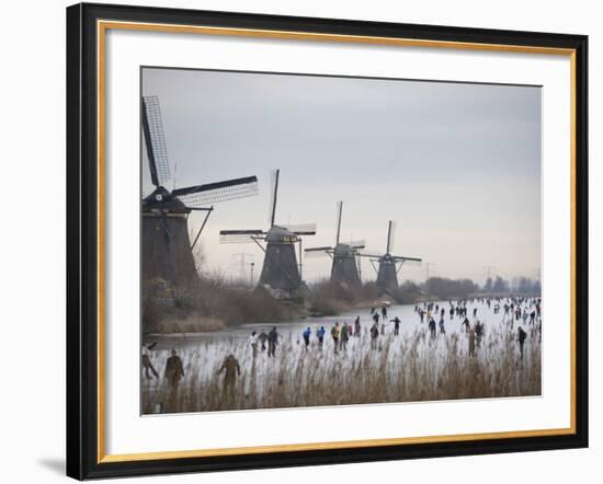 People Skate on Frozen Canals in Kinderdijk's Mill Area, a UNESCO World Heritage Site, Netherlands-null-Framed Photographic Print