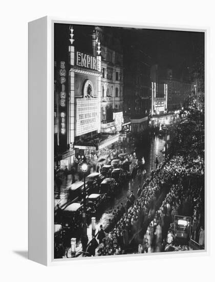 People Waiting in Front of the Brightly Lighted Empire Theatre for the Royal Film Performance-Cornell Capa-Framed Premier Image Canvas