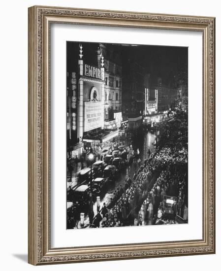 People Waiting in Front of the Brightly Lighted Empire Theatre for the Royal Film Performance-Cornell Capa-Framed Photographic Print