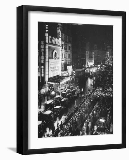 People Waiting in Front of the Brightly Lighted Empire Theatre for the Royal Film Performance-Cornell Capa-Framed Photographic Print