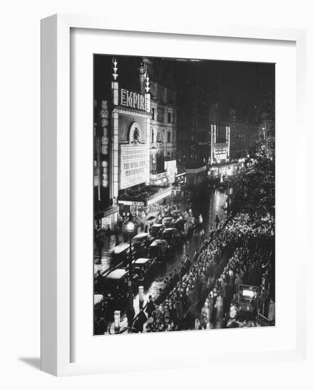 People Waiting in Front of the Brightly Lighted Empire Theatre for the Royal Film Performance-Cornell Capa-Framed Photographic Print