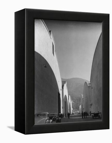 People Walking Between Sound Stages at Warner Bros. Studio-Margaret Bourke-White-Framed Premier Image Canvas