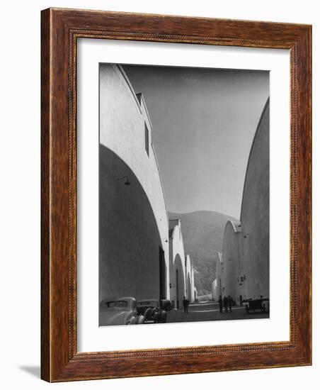 People Walking Between Sound Stages at Warner Bros. Studio-Margaret Bourke-White-Framed Premium Photographic Print