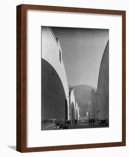 People Walking Between Sound Stages at Warner Bros. Studio-Margaret Bourke-White-Framed Premium Photographic Print