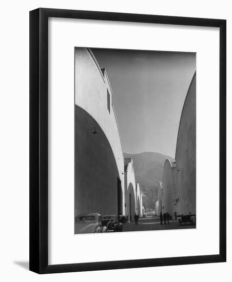 People Walking Between Sound Stages at Warner Bros. Studio-Margaret Bourke-White-Framed Premium Photographic Print