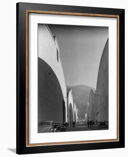 People Walking Between Sound Stages at Warner Bros. Studio-Margaret Bourke-White-Framed Premium Photographic Print