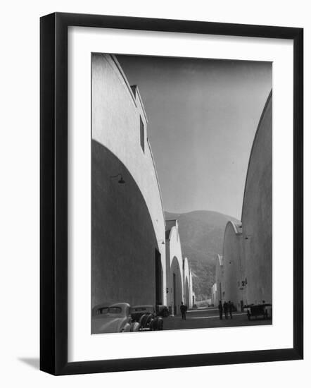 People Walking Between Sound Stages at Warner Bros. Studio-Margaret Bourke-White-Framed Premium Photographic Print