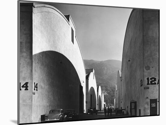 People Walking Between Sound Stages at Warner Brothers Studio-Margaret Bourke-White-Mounted Photographic Print