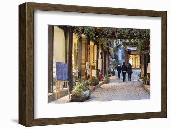 People walking through street, Lijiang, UNESCO World Heritage Site, Yunnan, China, Asia-Ian Trower-Framed Photographic Print