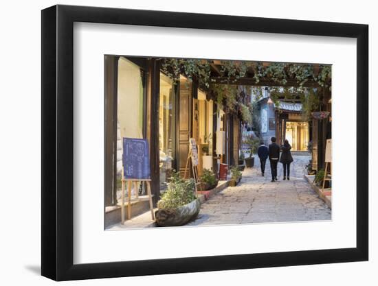 People walking through street, Lijiang, UNESCO World Heritage Site, Yunnan, China, Asia-Ian Trower-Framed Photographic Print