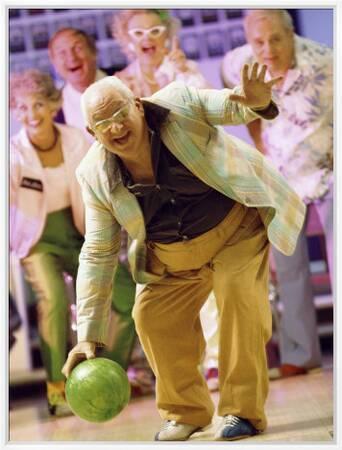 People Watching a Senior Man Bowling at a Bowling Alley' Photographic Print