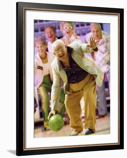 People Watching a Senior Man Bowling at a Bowling Alley-null-Framed Photographic Print