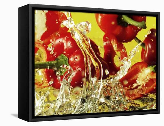 Peppers Falling into Water Against Yellow Background-Michael Meisen-Framed Premier Image Canvas