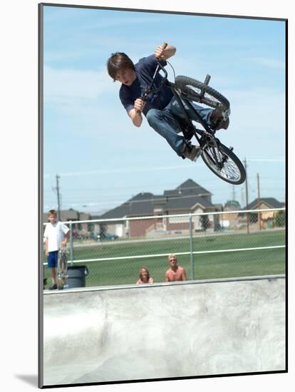 Performing a Bicycle Stunt-null-Mounted Photographic Print