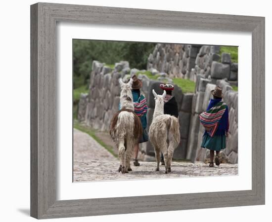 Peru, Native Indian Women Lead their Llamas Past the Ruins of Saqsaywaman-Nigel Pavitt-Framed Photographic Print