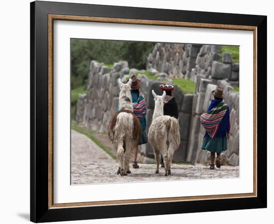 Peru, Native Indian Women Lead their Llamas Past the Ruins of Saqsaywaman-Nigel Pavitt-Framed Photographic Print