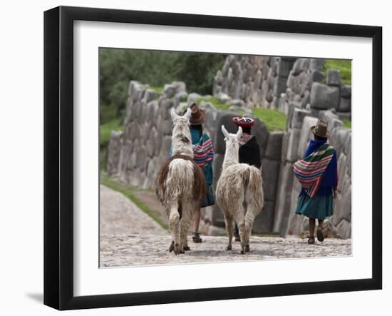 Peru, Native Indian Women Lead their Llamas Past the Ruins of Saqsaywaman-Nigel Pavitt-Framed Photographic Print