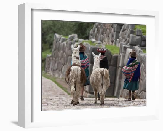 Peru, Native Indian Women Lead their Llamas Past the Ruins of Saqsaywaman-Nigel Pavitt-Framed Photographic Print