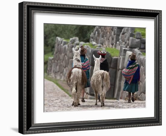 Peru, Native Indian Women Lead their Llamas Past the Ruins of Saqsaywaman-Nigel Pavitt-Framed Photographic Print