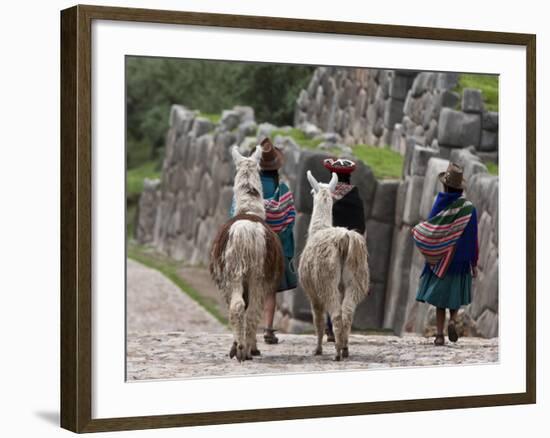 Peru, Native Indian Women Lead their Llamas Past the Ruins of Saqsaywaman-Nigel Pavitt-Framed Photographic Print