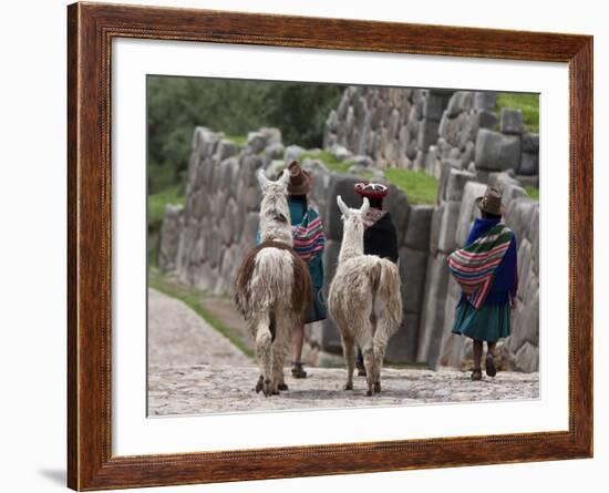 Peru, Native Indian Women Lead their Llamas Past the Ruins of Saqsaywaman-Nigel Pavitt-Framed Photographic Print