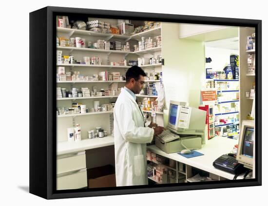 Pharmacist Using a Computer In a Pharmacy-Geoff Tompkinson-Framed Premier Image Canvas