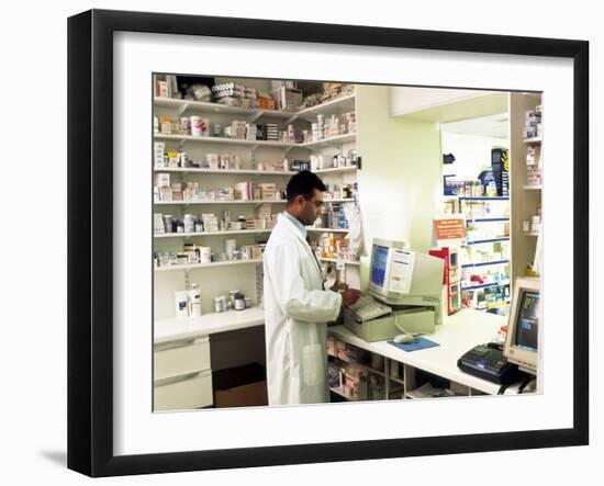 Pharmacist Using a Computer In a Pharmacy-Geoff Tompkinson-Framed Photographic Print