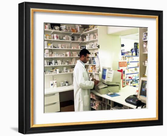 Pharmacist Using a Computer In a Pharmacy-Geoff Tompkinson-Framed Photographic Print