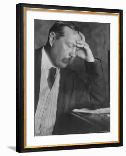 Photo by E. O. Hoppe of Author Sir Arthur Conan Doyle Seated, Eyes Downcast, in Reflective Pose-Emil Otto Hoppé-Framed Premium Photographic Print