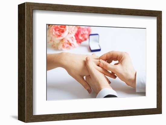 Picture of Man Putting Wedding Ring on Woman Hand-dolgachov-Framed Photographic Print