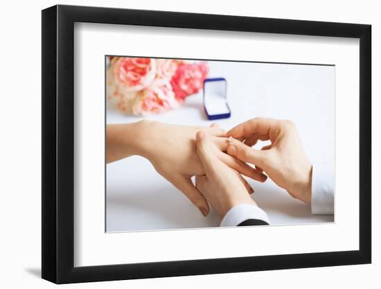 Picture of Man Putting Wedding Ring on Woman Hand-dolgachov-Framed Photographic Print