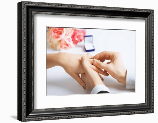 Picture of Man Putting Wedding Ring on Woman Hand-dolgachov-Framed Photographic Print