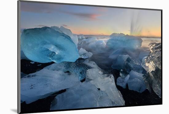 Pieces of glacial ice over black sand being washed by waves, Iceland-Raul Touzon-Mounted Photographic Print