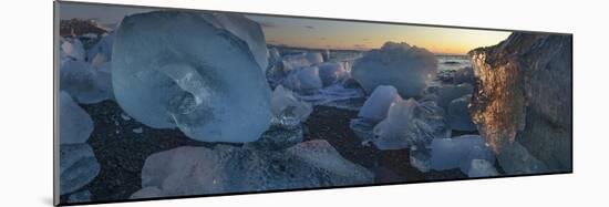 Pieces of glacial ice over black sand being washed by waves, Iceland-Raul Touzon-Mounted Photographic Print