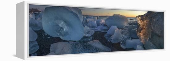 Pieces of glacial ice over black sand being washed by waves, Iceland-Raul Touzon-Framed Premier Image Canvas