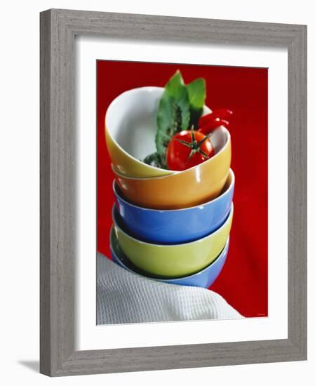 Pile of Soup Bowls with Tomato, Bay Leaf and Chilis-Karl Newedel-Framed Photographic Print