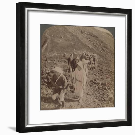 'Pilgrims, at end of weary ascent, in worship encircling crater of sacred Fujiyama, Japan', 1904-Unknown-Framed Photographic Print