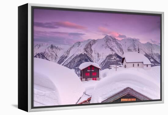 Pink Sky at Sunset Frames the Snowy Mountain Huts and Church, Bettmeralp, District of Raron-Roberto Moiola-Framed Premier Image Canvas