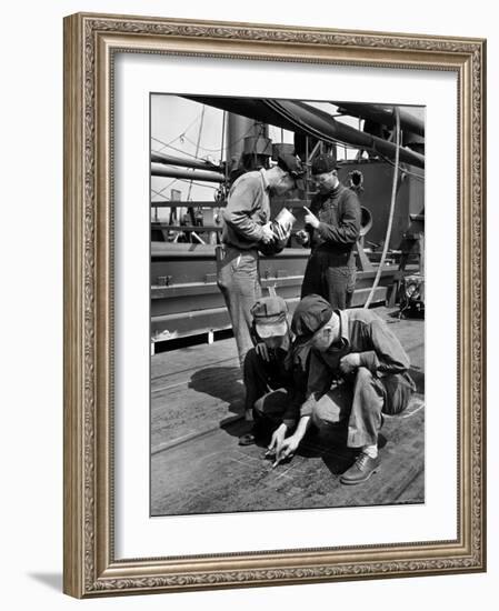 Pipefitters and Welders Discussing Installation During Shipbuilding Process-George Strock-Framed Photographic Print
