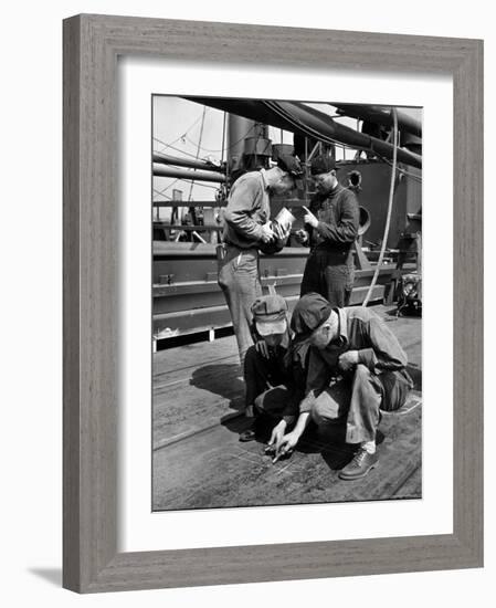 Pipefitters and Welders Discussing Installation During Shipbuilding Process-George Strock-Framed Photographic Print