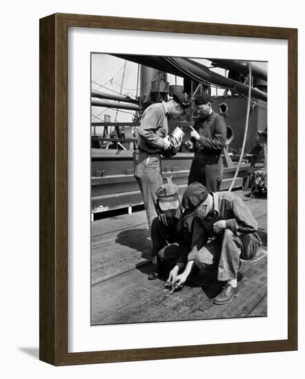 Pipefitters and Welders Discussing Installation During Shipbuilding Process-George Strock-Framed Photographic Print