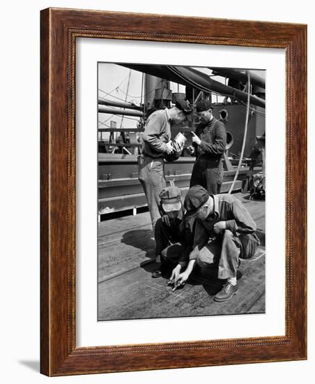 Pipefitters and Welders Discussing Installation During Shipbuilding Process-George Strock-Framed Photographic Print