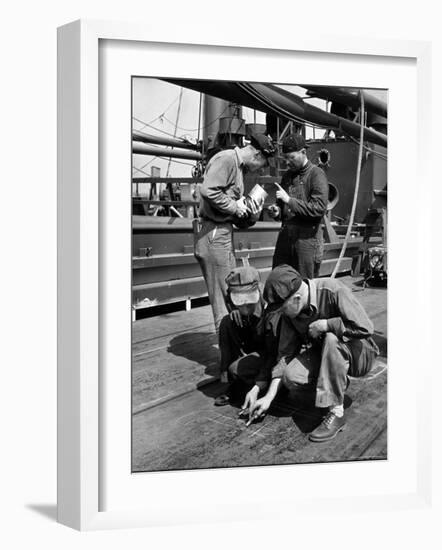 Pipefitters and Welders Discussing Installation During Shipbuilding Process-George Strock-Framed Photographic Print